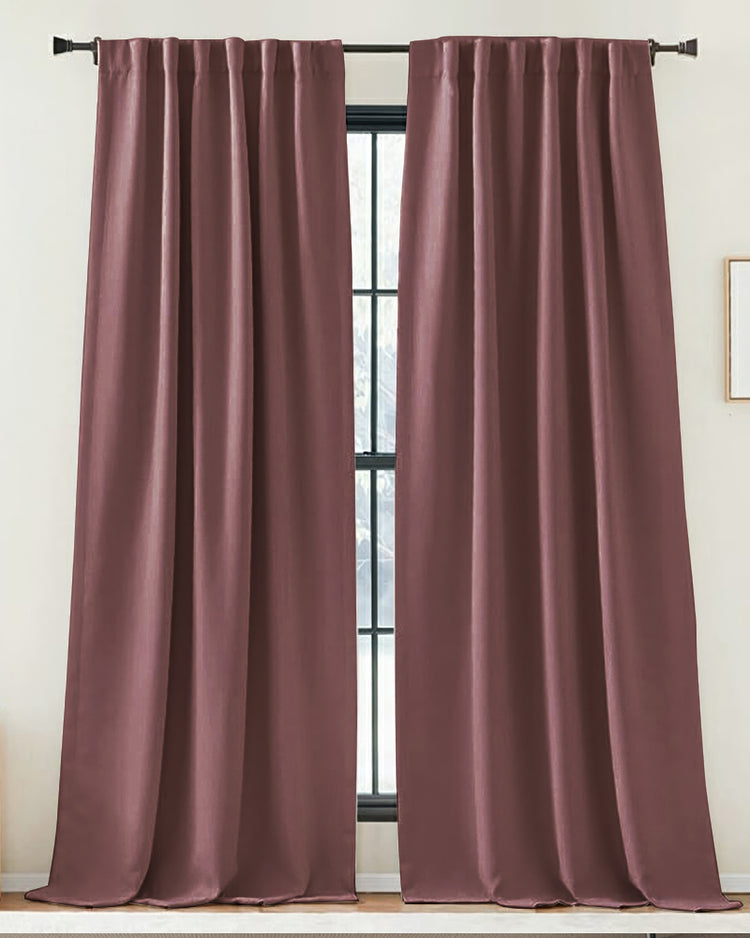 Zoe custom plum linen look drapery panels with soft folds, hung on a black rod, creating tailored window treatments.
