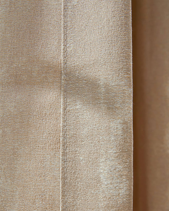 Close-up of Glimmer Linen Blend Lightweight Textured Custom Curtain fabric in light beige, showing intricate weave and subtle sheen.