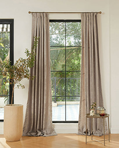 Taupe Glimmer Linen Blend Custom Curtains with elegant pinch pleat header on a window overlooking greenery, enhancing home decor.