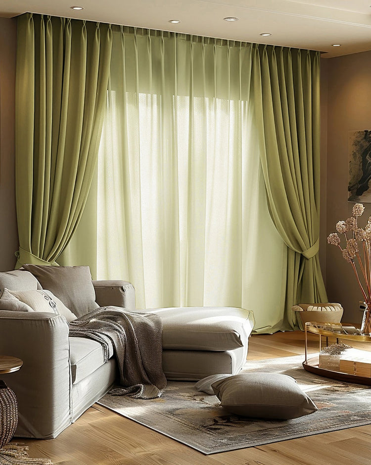 Luxurious living room with sage Quinn 100% Blackout OEKO velvet pinch pleat custom curtains & sheers for light control & privacy.