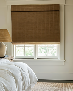 Tan Hana Bamboo Motorized Woven Shade installed on a bedroom window, a stylish custom window treatment for privacy & light control.