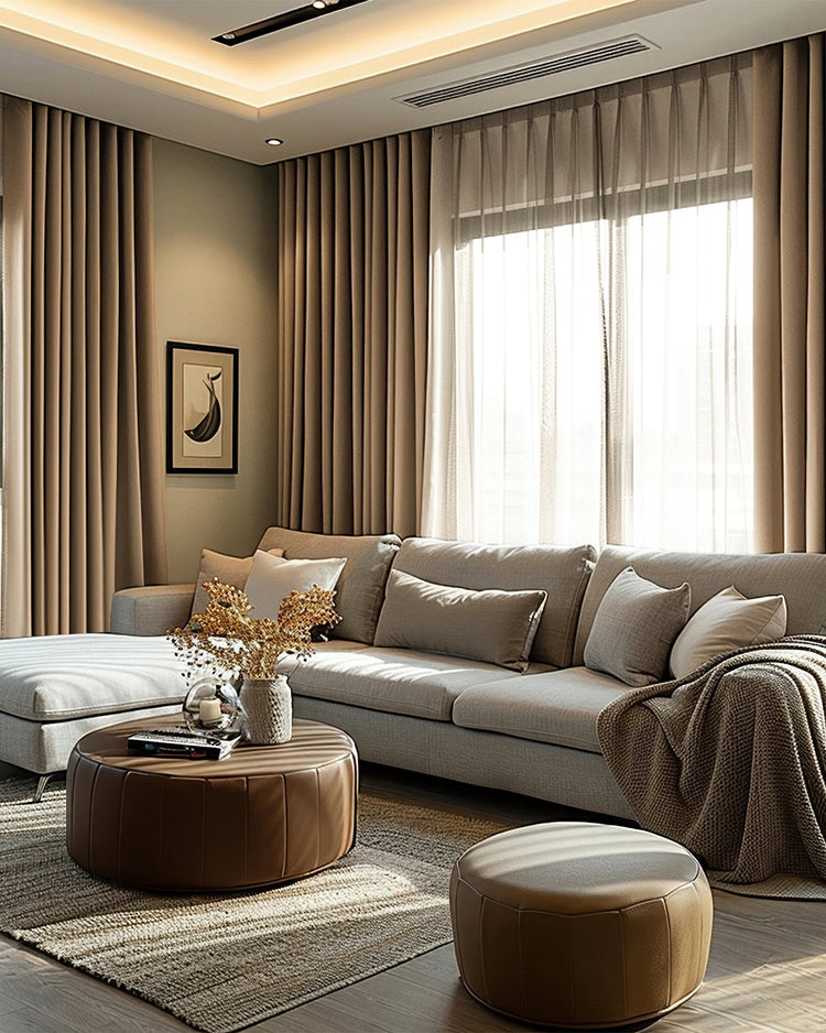 Victoria 100% Blackout Linen Custom Curtains in warm beige, featuring elegant pleats, provide superior light control in a chic living room.