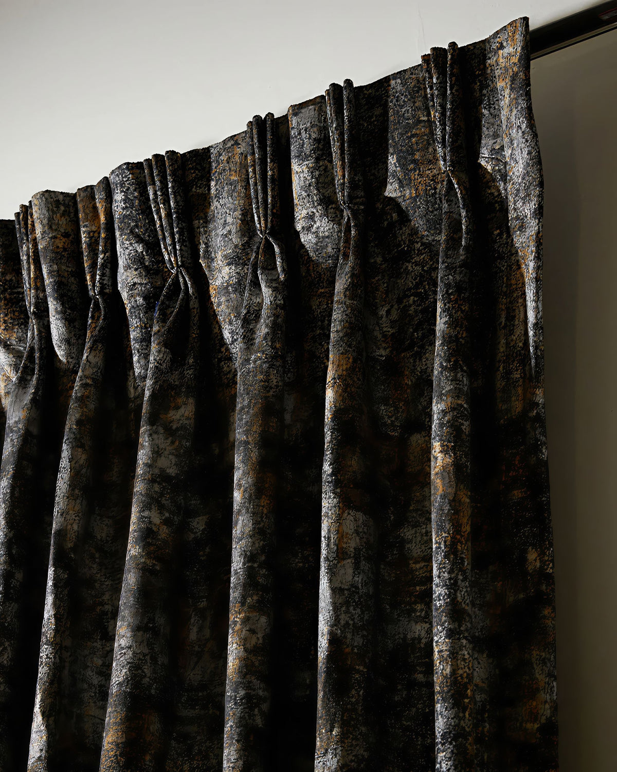 Luxurious custom velvet curtain with Impression foil print, showcasing a rich black, gold, and silver abstract pattern.