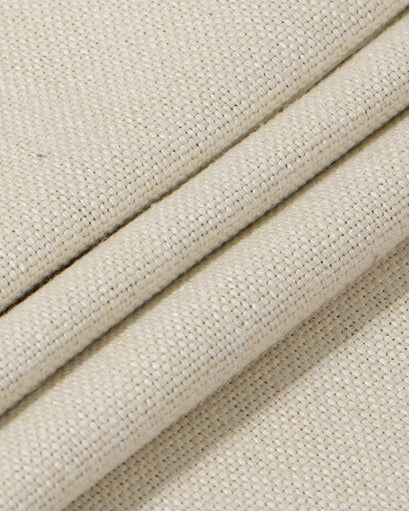 Close-up of textured, folded natural beige heavyweight pure linen fabric, ideal for 100% blackout custom curtains & drapery.