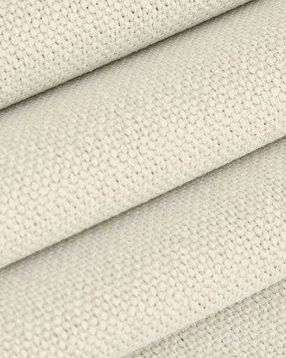 Close-up of the soft, creamy Zoe linen look custom drapery fabric, highlighting its woven texture and premium feel.