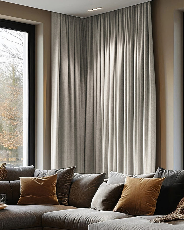 Florence heavyweight woven textured custom blackout curtains in light greige, providing elegant privacy for a modern corner window.