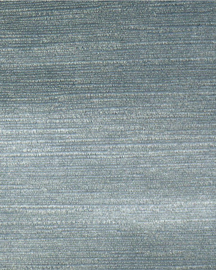 Close-up of luxurious blue Rome foil printed velvet custom curtain fabric, showcasing its shimmering horizontal texture for elegant window treatments.
