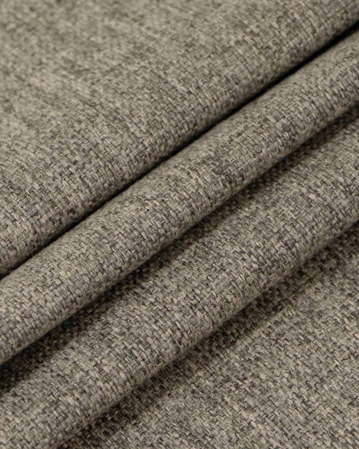 Close-up of dense, textured grey Victoria 100% blackout linen look heavyweight custom curtain fabric folds.