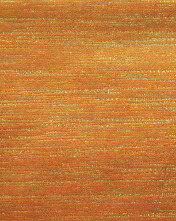 Close-up of luxurious orange Rome foil printed velvet custom curtain fabric, showcasing subtle horizontal shimmering lines. Italian design.