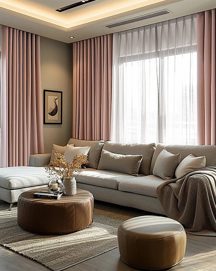 Blush pink custom linen blackout curtains frame a bright living room window with sheer drapery, complementing a sofa and decor.