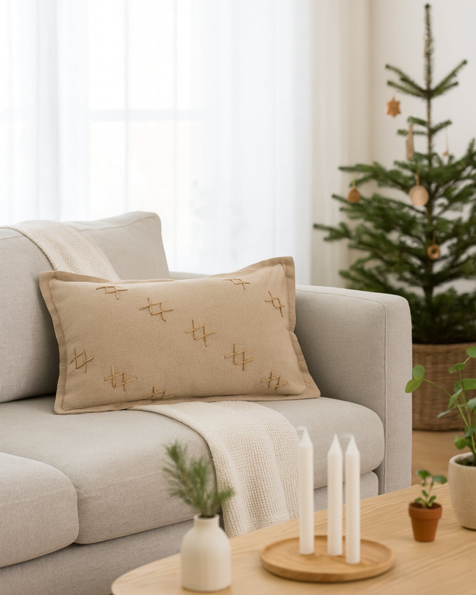 Double-sided beige Arden Textured Yarn Stitched Lumbar Pillowcase with distinctive cross-stitch design on a light grey sofa, cozy home decor.