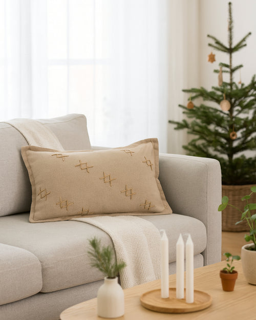 Double-sided beige Arden Textured Yarn Stitched Lumbar Pillowcase with distinctive cross-stitch design on a light grey sofa, cozy home decor.