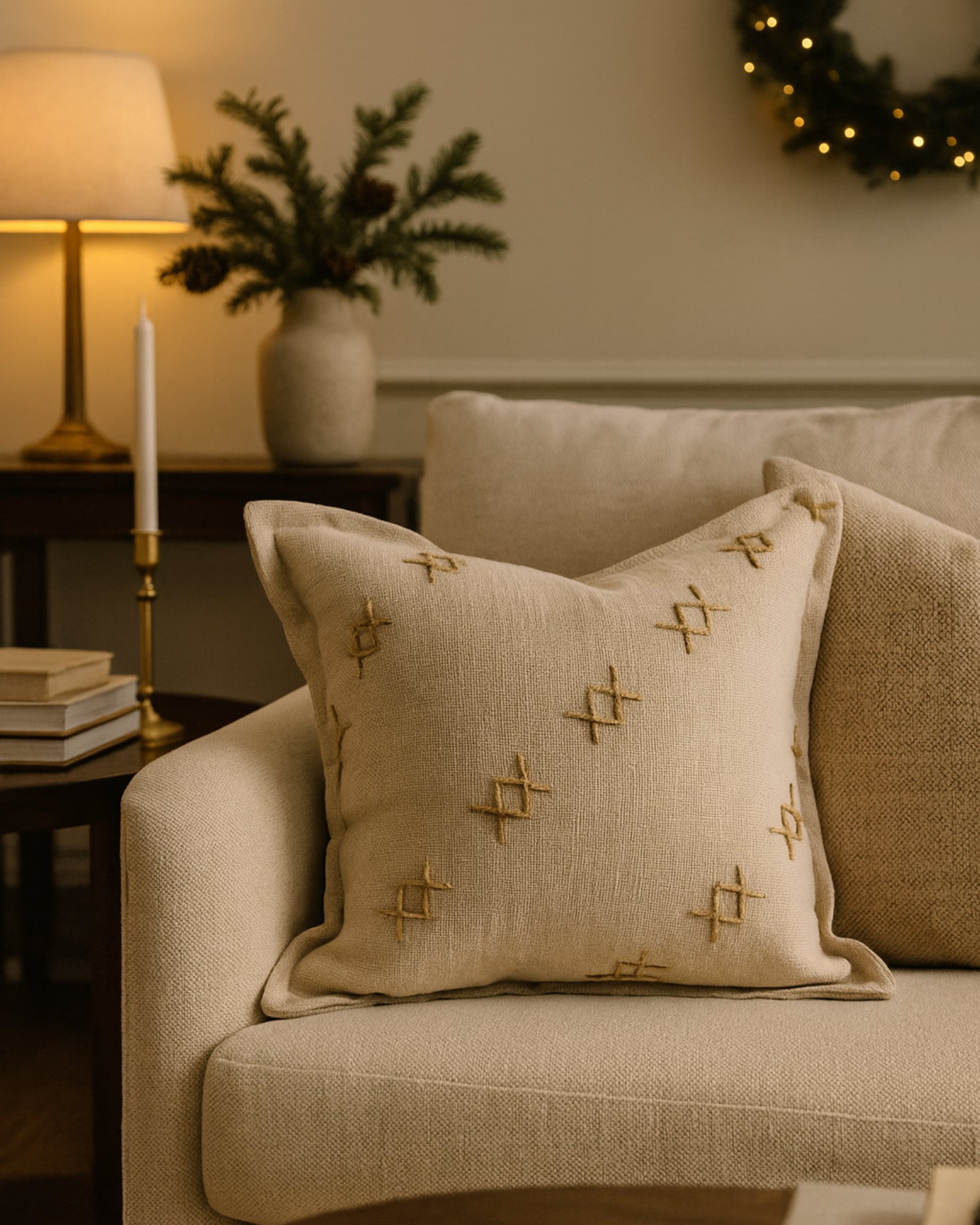 Elegant Arden textured yarn stitched throw pillowcase with decadent cross-patterned details on a neutral sofa. High-end home decor.