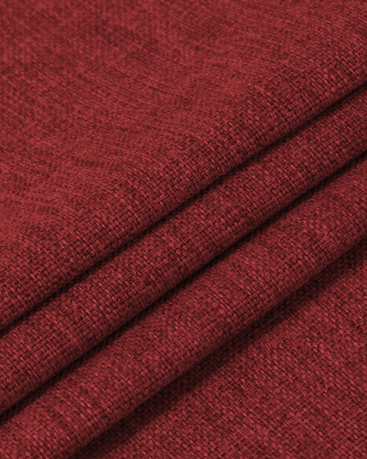 Close-up of richly textured deep red OEKO linen look heavyweight blackout custom curtain fabric with visible weave folds.