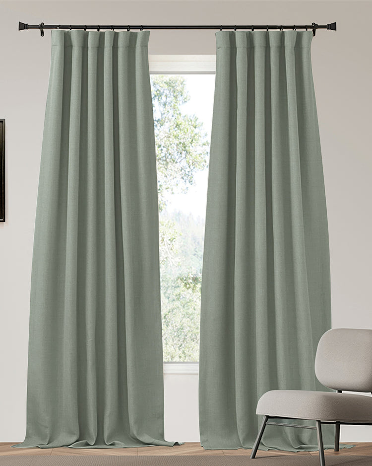 Zoe sage green linen look heavyweight 100% blackout custom curtains with a pinch pleat header on a black rod.