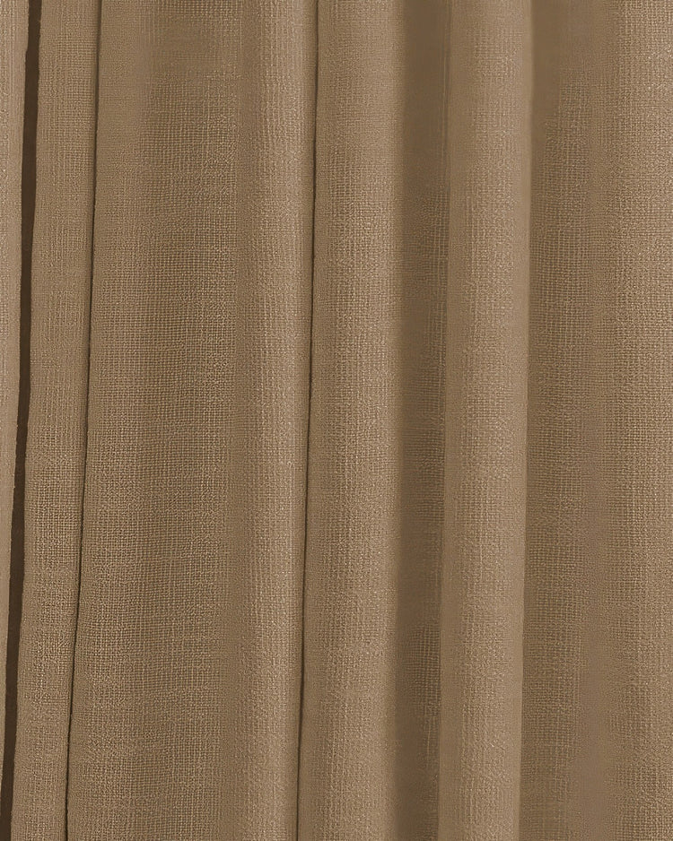 Close-up of the textured, warm brown Traunsee custom curtain fabric, highlighting its rich cotton blend weave and elegant folds.
