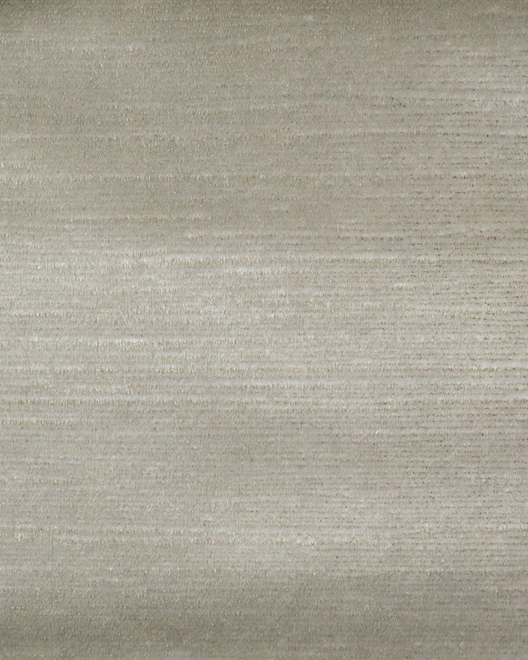 Close-up of custom Rome Foil Printed Velvet drapery fabric, highlighting its subtle texture and soft light beige hue.