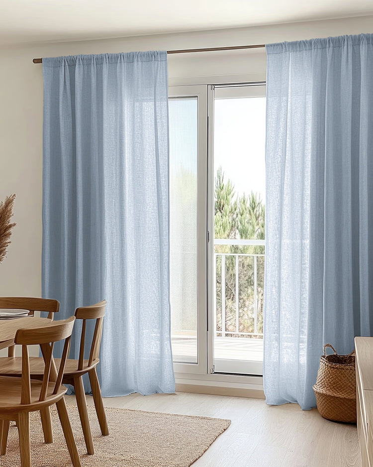Sky blue yarn linen look sheer custom rod pocket curtains on a dark rod, softly diffusing light for privacy in a modern home.