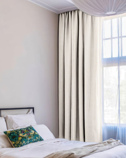 Zoe 100% blackout linen look custom curtain gracefully hung in a modern bedroom, demonstrating superior light control and privacy.