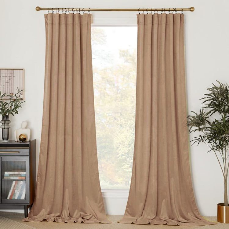 Warm beige Classic Velvet Custom Curtains, hung with rings on a gold rod, providing luxurious window treatments for light control & privacy.