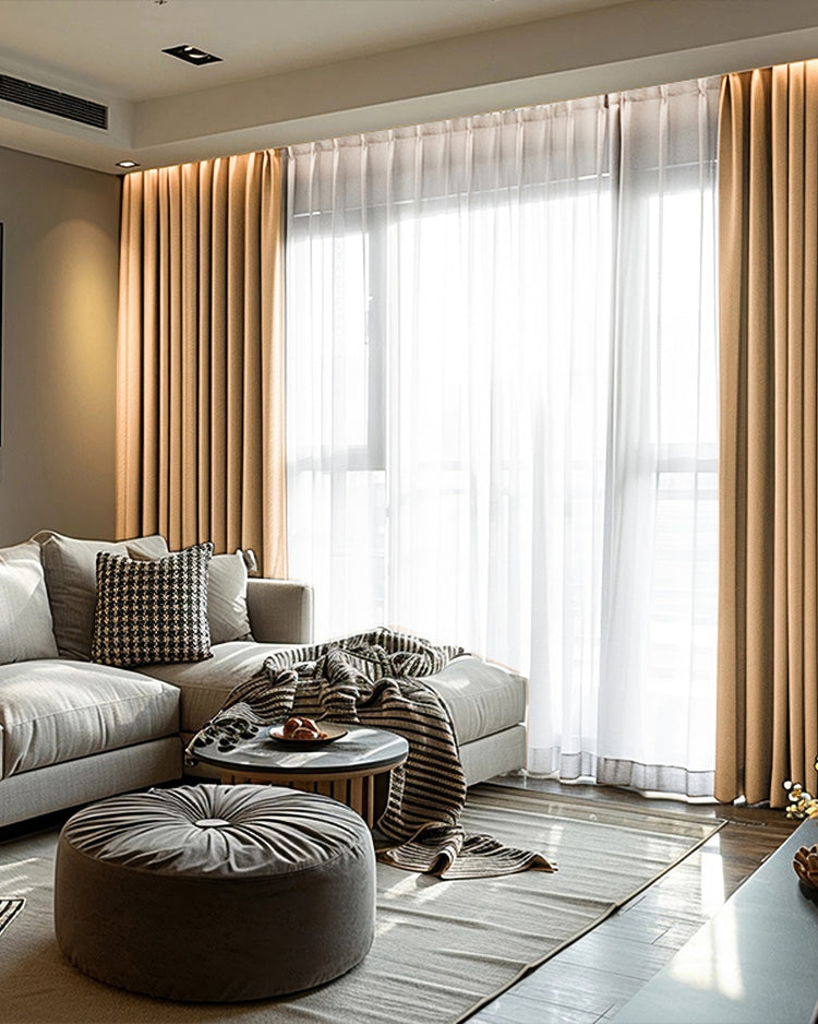 Elegant living room with custom linen look blackout curtains in light brown, offering privacy & light control with sheer white drapes.