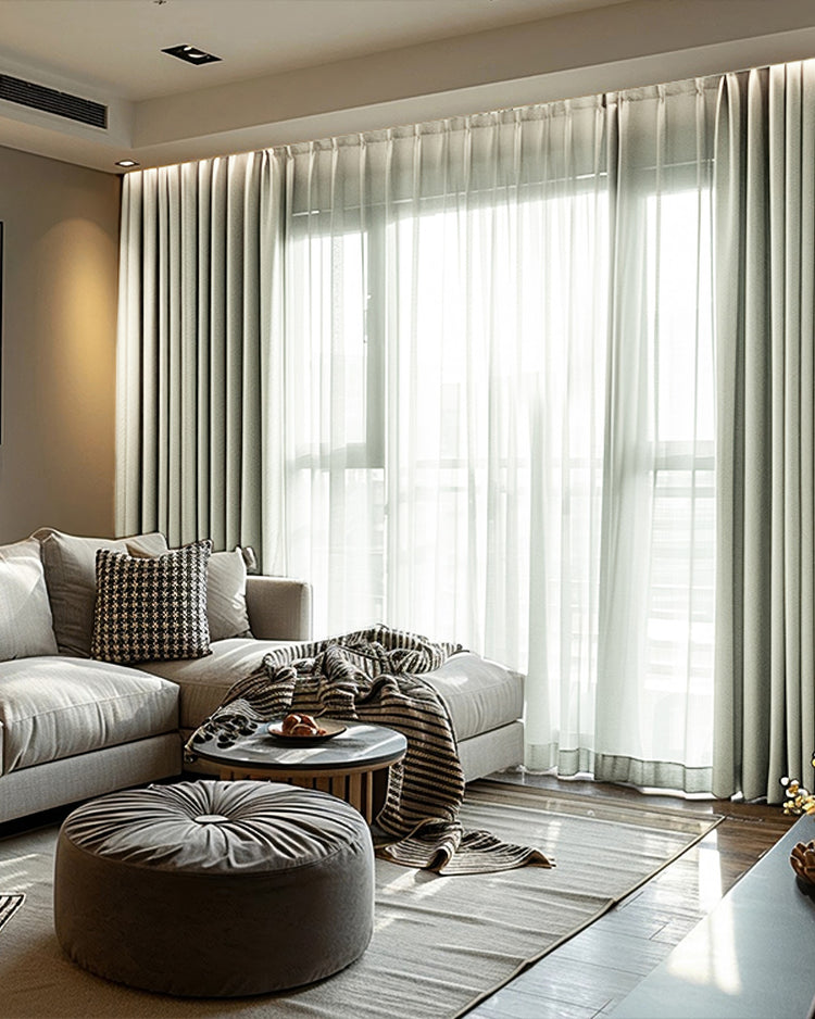 Modern living room with light grey Cronin linen look blackout custom curtains & sheer white drapes on a large window.