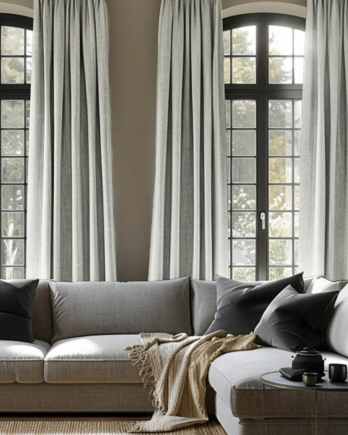 Elegant gray Cronin linen look blackout custom curtains on arched windows, offering light control & privacy in a modern living space.