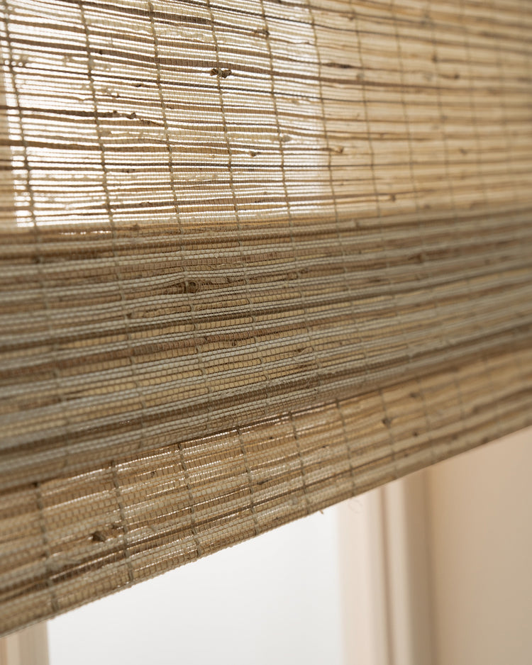 Close-up of Mia Ecru jute woven shade, showcasing its natural texture, horizontal weave, and light filtering—perfect for custom window treatments.
