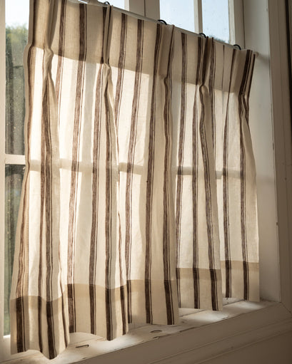 Sheer Cate pure linen cafe curtain with brown vertical stripes on a white window, perfect for light filtering & custom aesthetics.