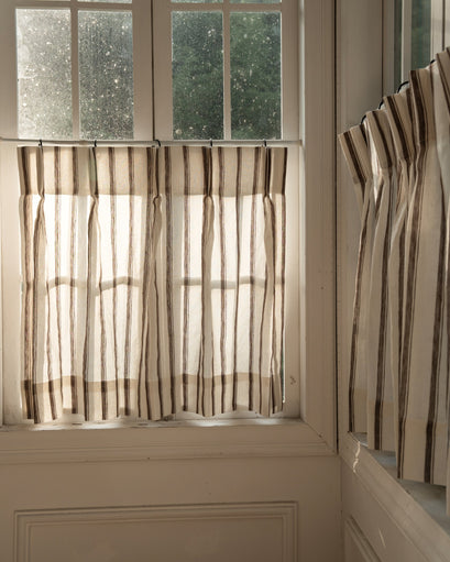 Cate pure linen striped cafe curtains on a sunlit window, providing privacy & filtered natural light.
