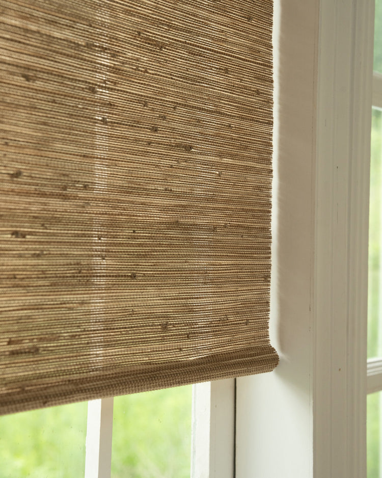 Detailed view of a Mia Jute Woven Shade in Straw, highlighting its rich, natural texture and custom light filtering for home decor.