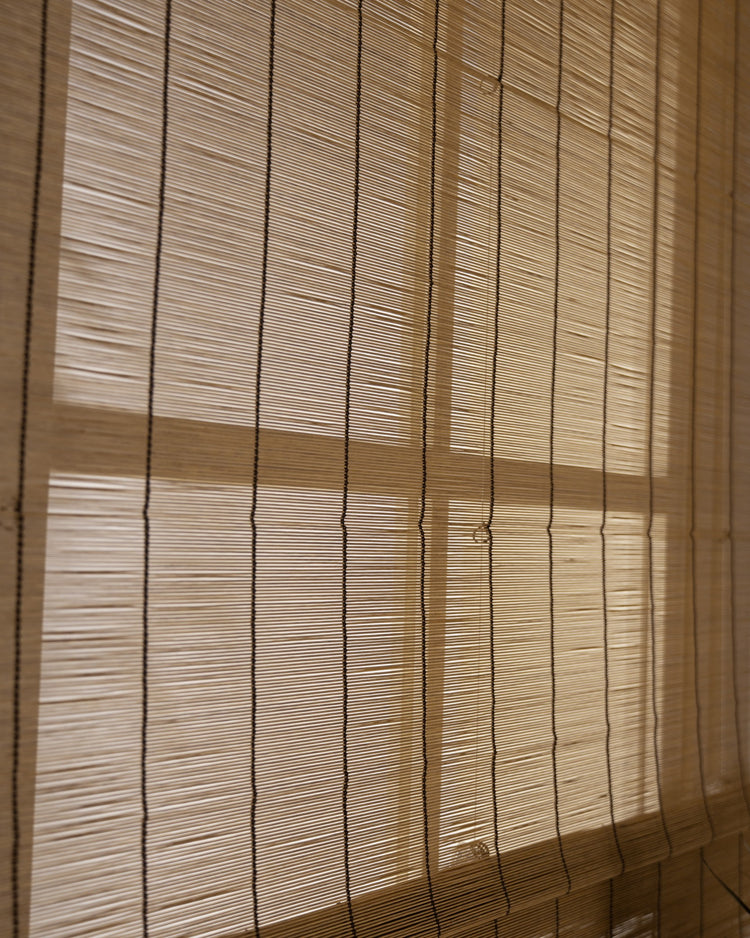 Toni Tan bamboo woven shade creating soft light filtering, highlighting its beautiful natural texture and weave.