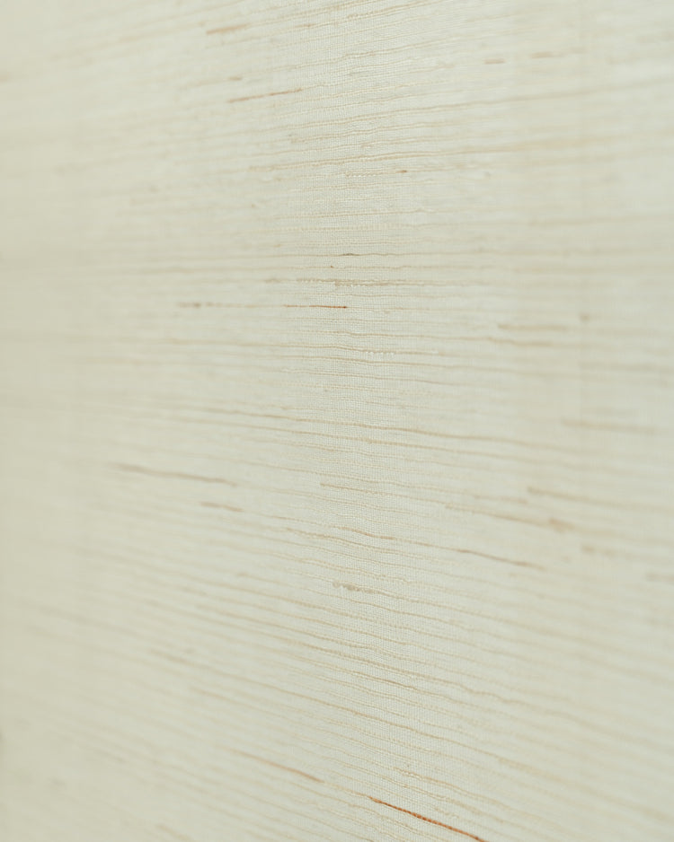 Close-up of Yuki Linen Woven Shade in white, showcasing the natural texture and horizontal weave of the pure linen fabric.