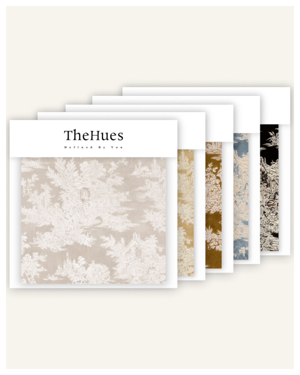 TheHues Zen Foil Printed Velvet patterned fabric swatches fanned out, showing beige toile, gold floral, blue, & black patterns.