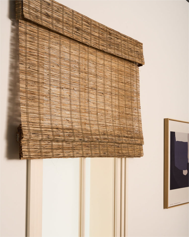 Rumi straw jute woven shade, showcasing its rich, coarse texture as a natural window treatment for elegant home decor.