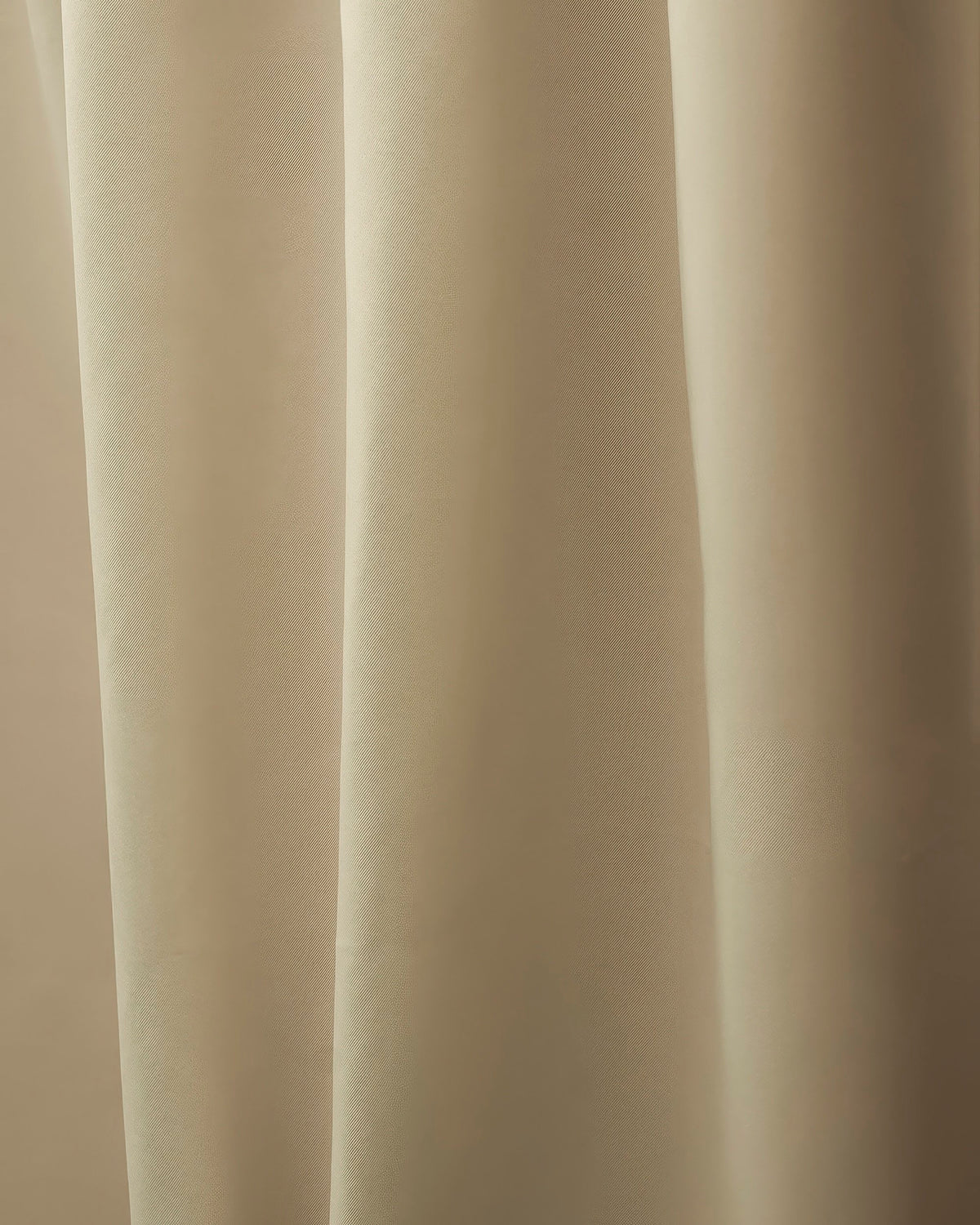 Close-up of elegant Hussein OEKO Certified custom curtain fabric with soft folds, showcasing its subtle texture for sophisticated home decor.
