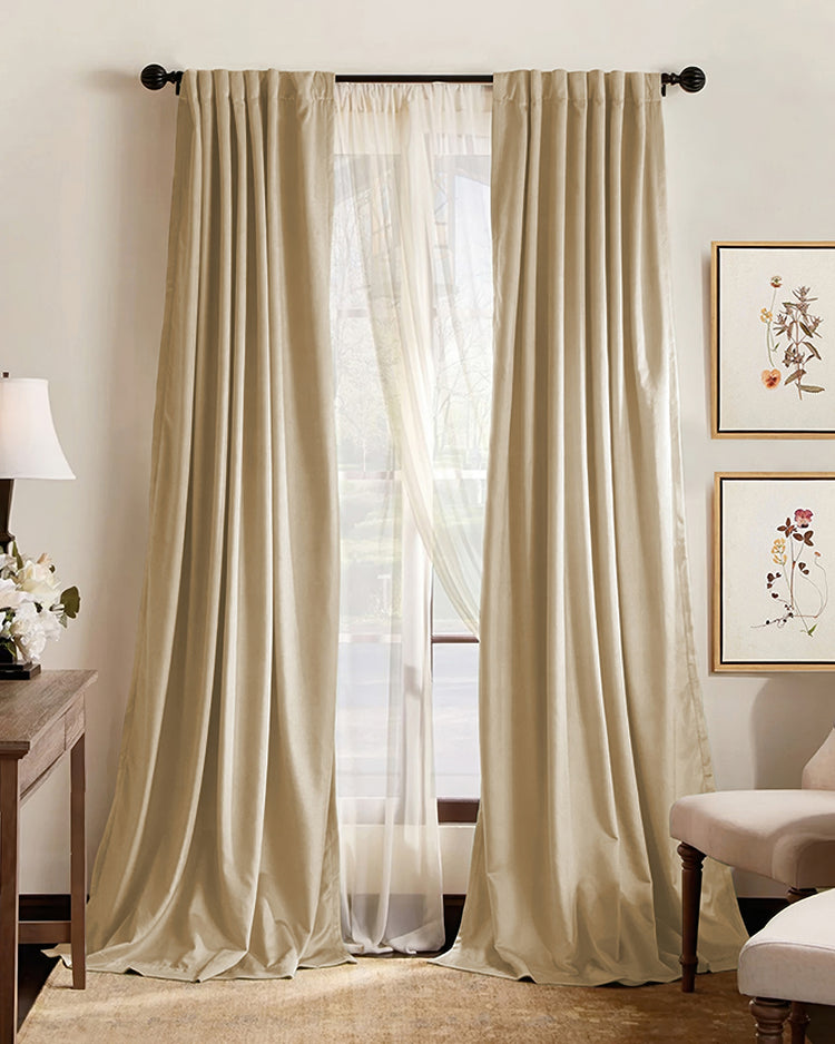 Light beige custom 100% blackout drapery with elegant pleats, layered over sheer drapes for optimal thermal & soundproof privacy.