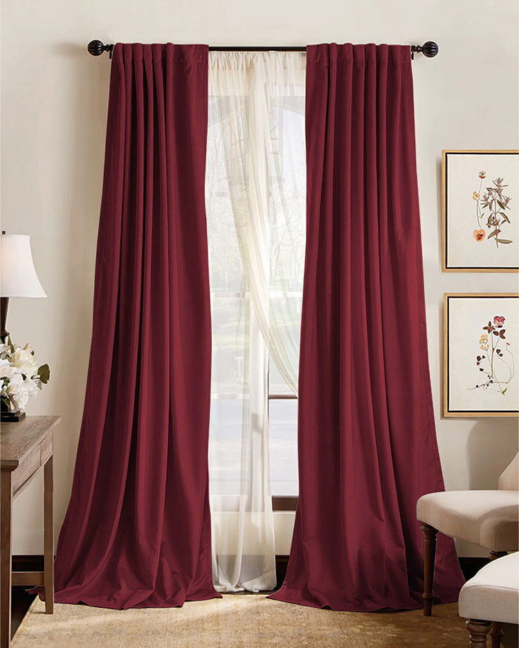 Elegant burgundy 100% blackout custom drapes with soundproof & thermal properties, layered with white sheer curtains for sophisticated home decor.