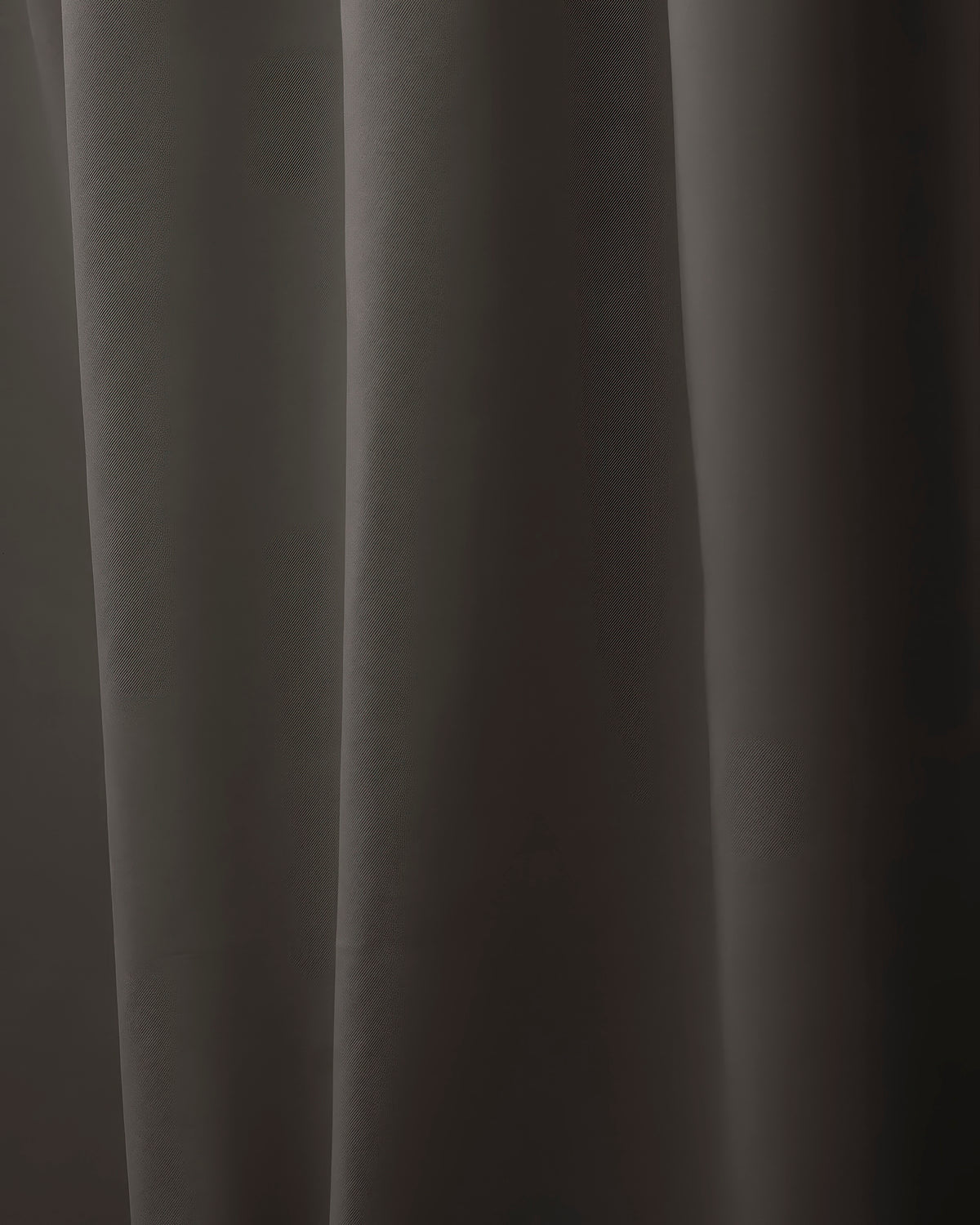 Close-up of Hussein OEKO Certified custom dark grey drapery fabric, highlighting its subtle diagonal weave texture and soft folds.
