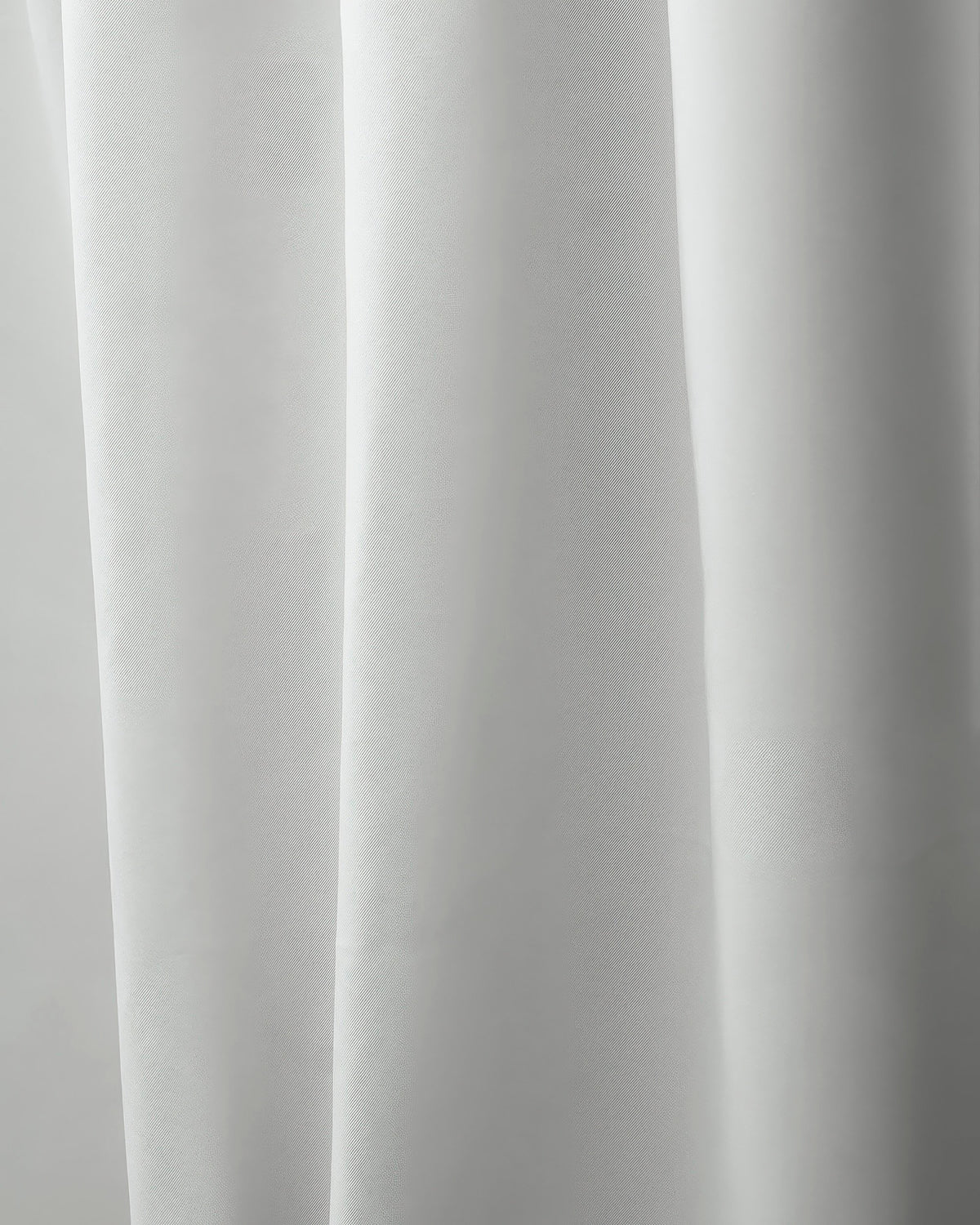 Close-up of Hussein OEKO Certified custom white drapery fabric, revealing its premium woven texture & soft, elegant folds.