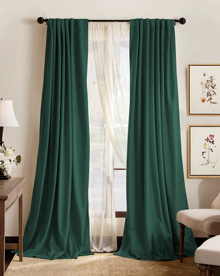 Custom emerald green blackout thermal drapery with elegant pinch pleat header for ultimate privacy and light control.