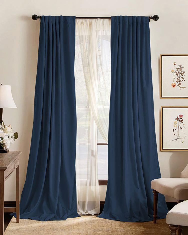 Hussein premium custom navy blue blackout curtains, elegantly pleated, layered with sheers for optimal light control & sophisticated home decor.