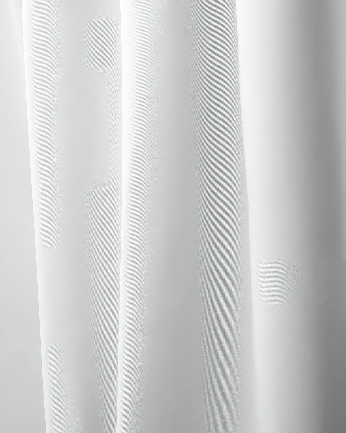 Close-up of white Hussein OEKO Certified custom curtain fabric with soft folds, highlighting its texture for elegant home decor.