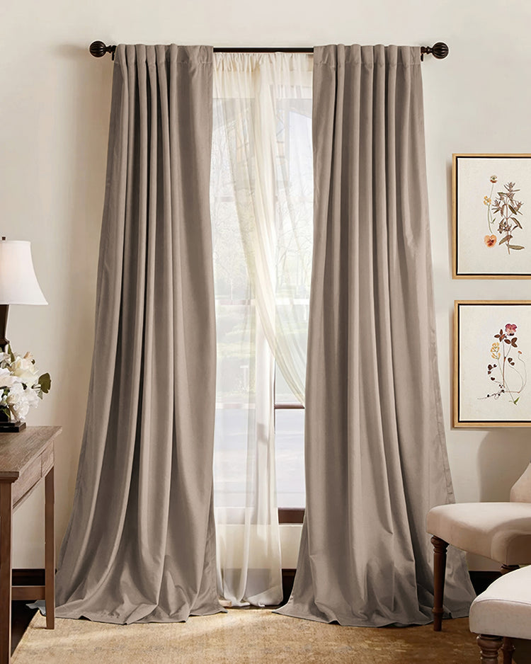 Made-to-measure premium taupe blackout custom curtains with elegant pleats, layered over sheers, offering light control & sophisticated home decor.