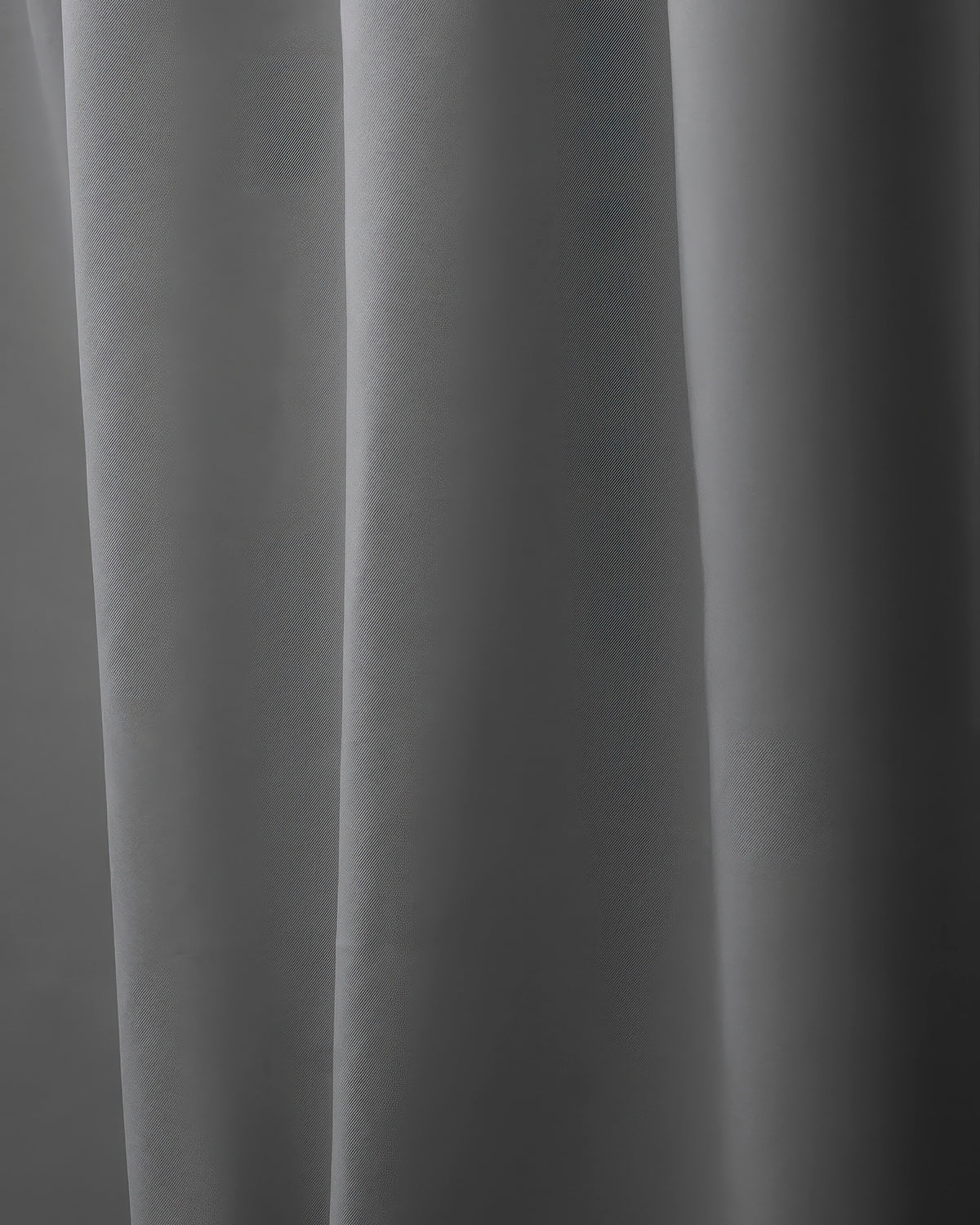 Deep gray Hussein OEKO Certified custom curtain with elegant vertical folds, offering sophisticated home aesthetics & light control.