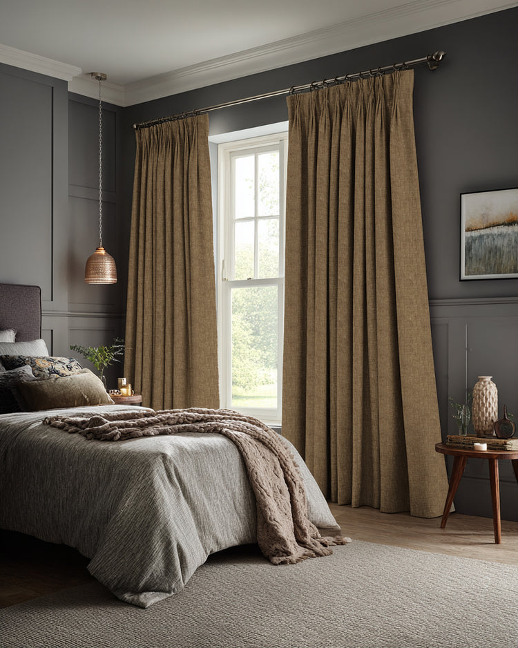 Pleated tan Kensington 100% blackout OEKO linen look custom curtains in a sophisticated bedroom, offering privacy & light control.