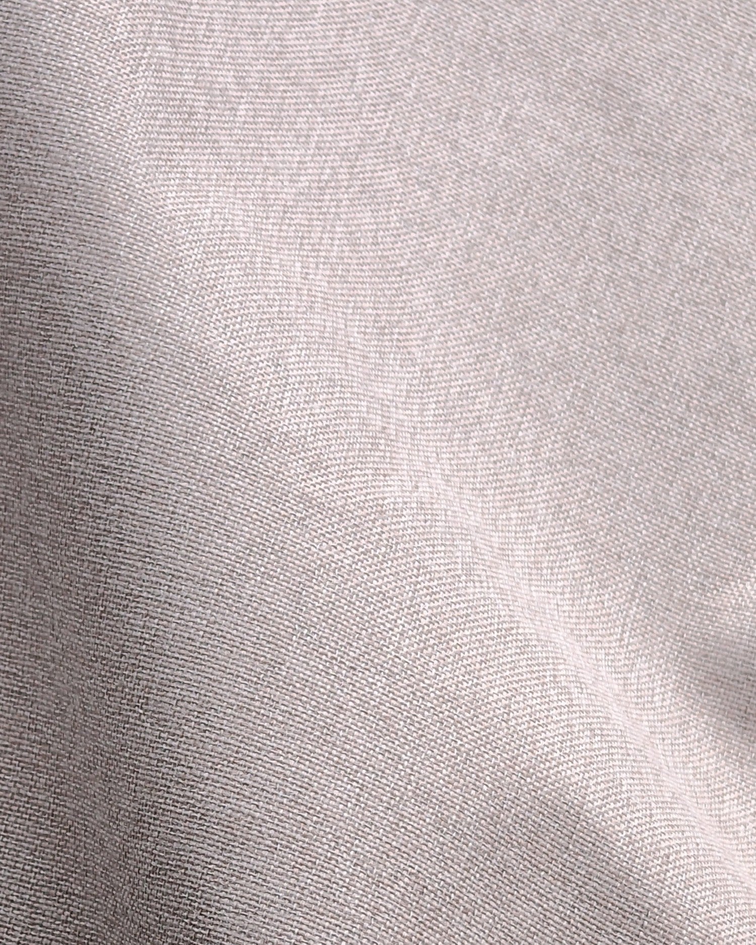 Close-up of the fine woven texture of Linden NFPA 701 IFR 100% blackout custom curtain in light silver-grey.