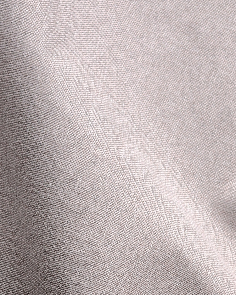 Close-up of the fine woven texture of Linden NFPA 701 IFR 100% blackout custom curtain in light silver-grey.