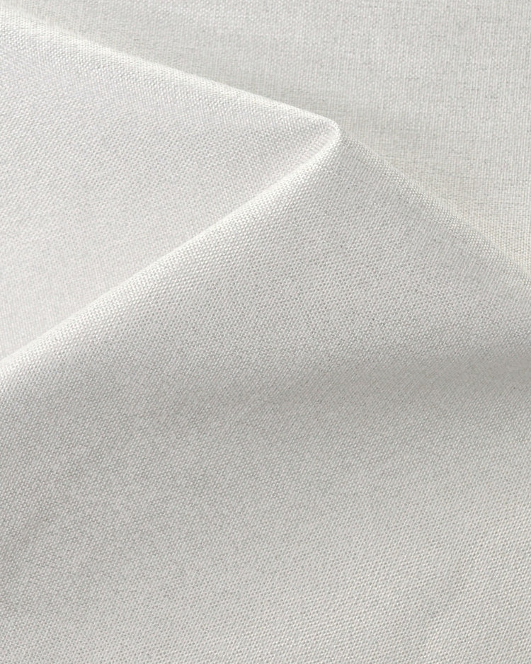 Close-up of white Linden NFPA 701 IFR 100% blackout custom curtain fabric showing a dense, textured linen-like weave.