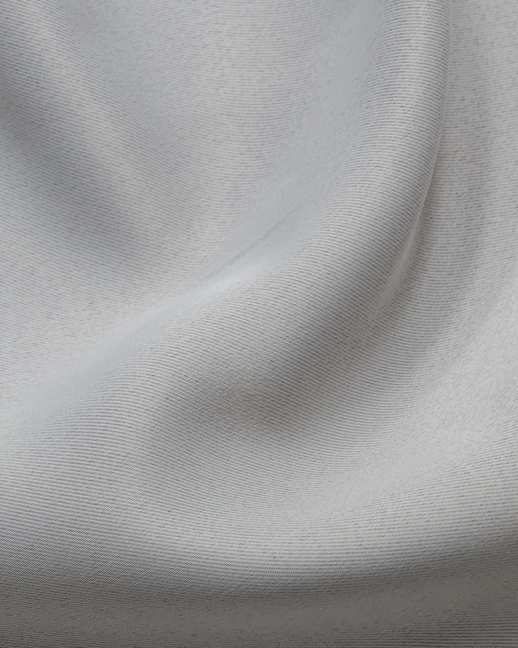 Close-up of white Linea NFPA 701 IFR room darkening custom curtain fabric texture with a fire retardant twill weave pattern.